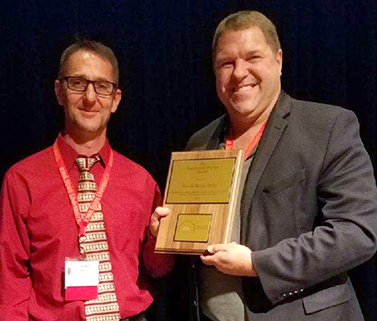 Dr. Darwin Reicks receives award from Dr. Chris Rademacher