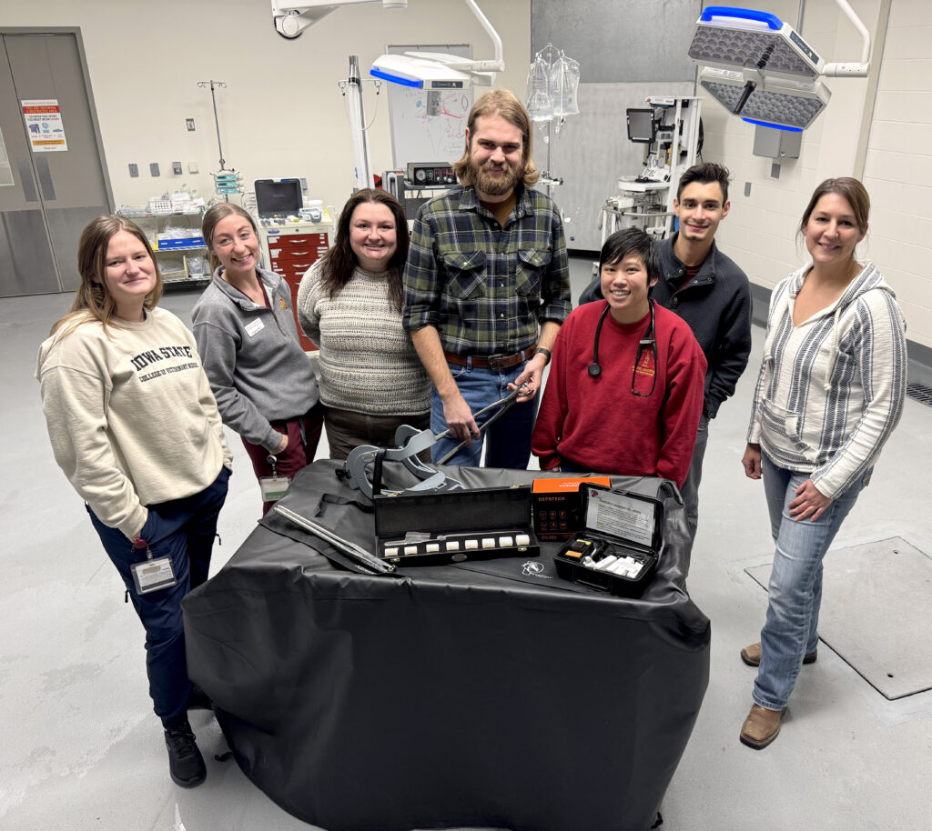 Veterinarians, technicians and students in dental surgery suite with new equipment