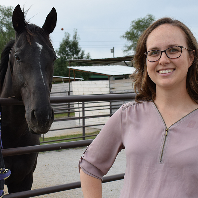 Dr. Jamie Kopper standing with horse