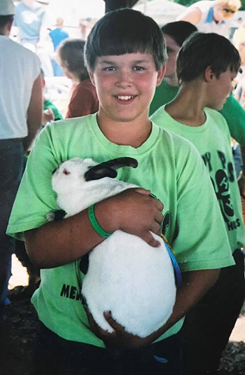 Young Zach Sauer showing rabbits