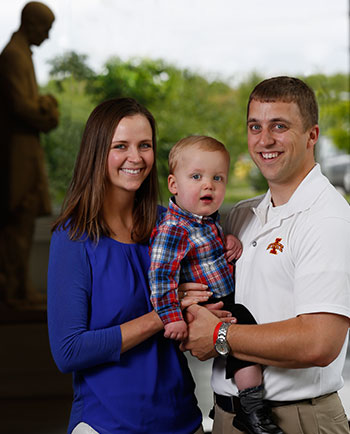 Schmitt family in front of Gentle Doctor statue