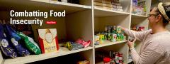 Restocking food shelves in the food pantry.