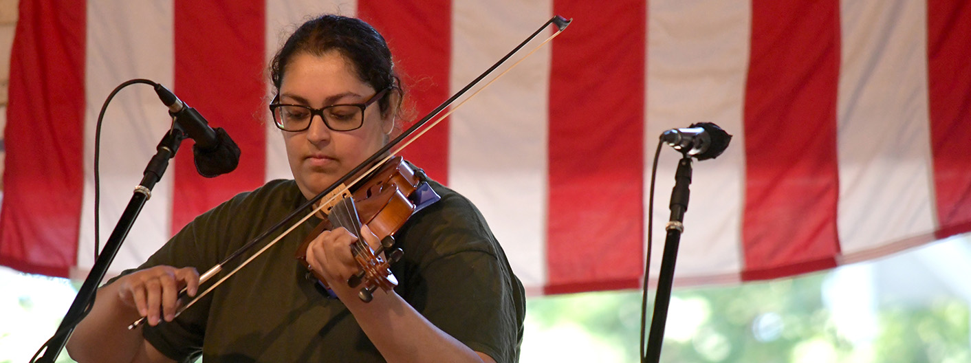 playing fiddle on stage