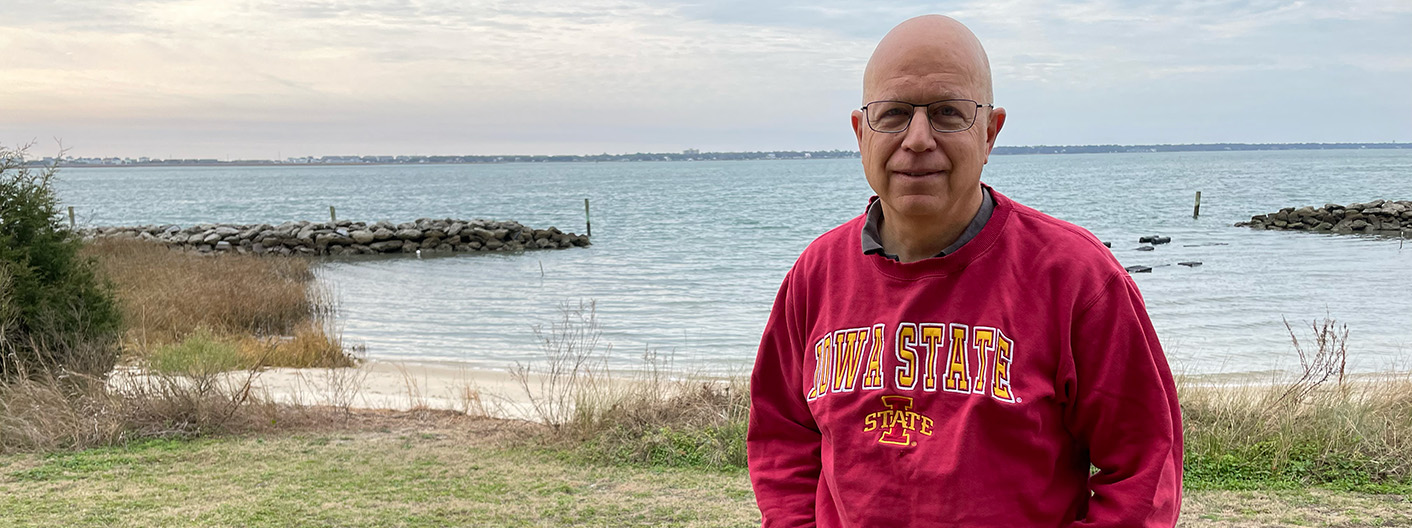 Dr. Craig Harms standing near coastline