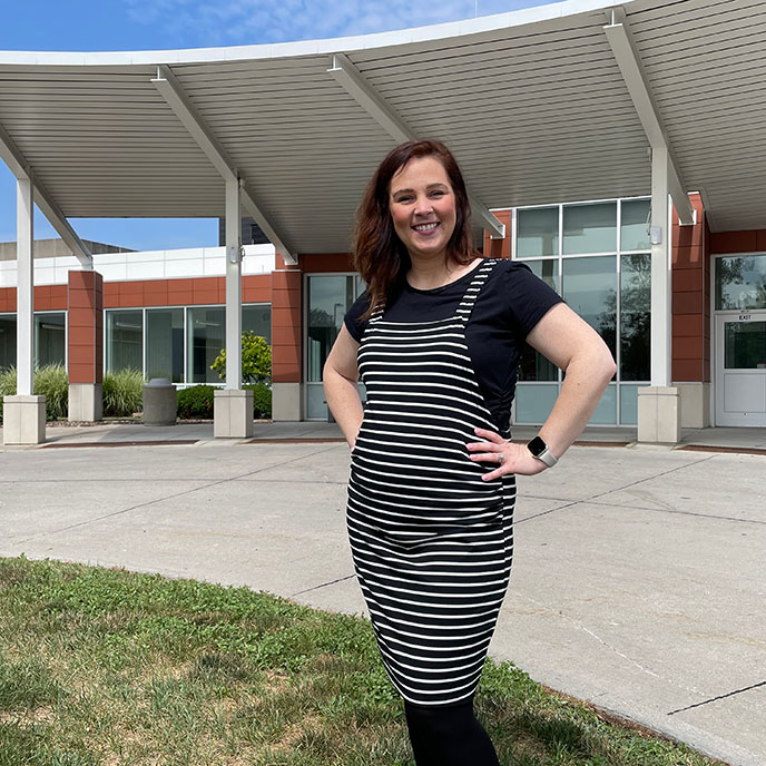 Maddie Moree standing in front of Lloyd Veterinary Medical Center