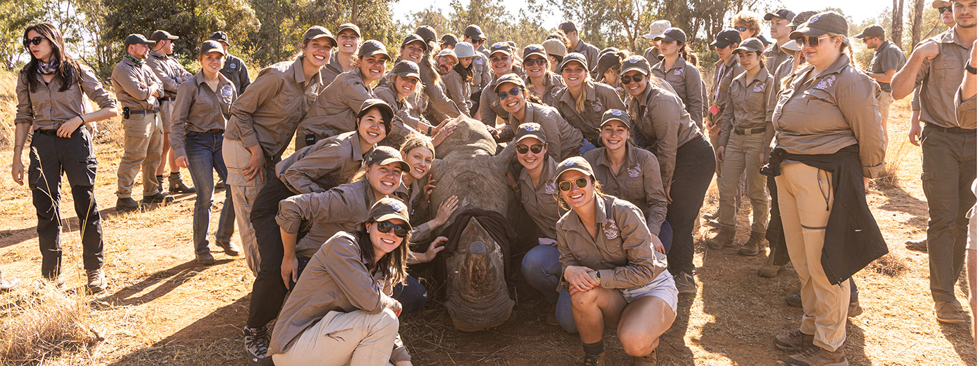 Leo Viollet with group surrounding rhino