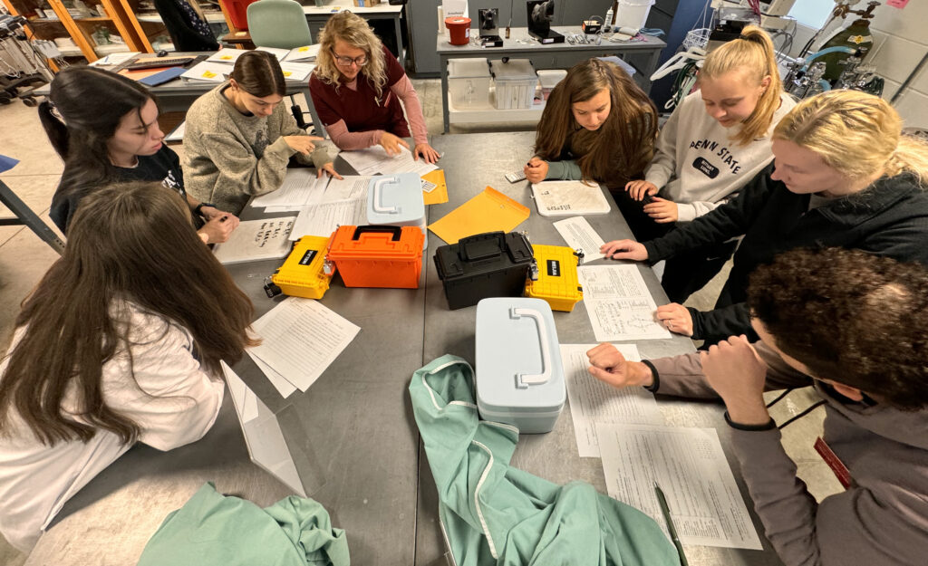 Veterinary students reviewing information on a table in the Clinical Skills Laboratory